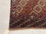 an image of a brown and blue rug with a tag on it