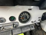 gauges on the dashboard of an old car