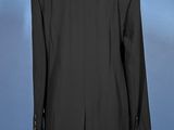 a black suit on a mannequin stand against a blue background