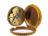 a gold pocket watch with a chain around it