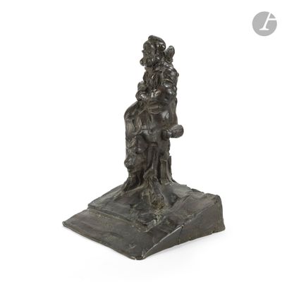 an image of a bronze statue of a woman sitting on a rock