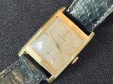 a watch that is sitting on a black cloth