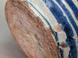 a blue and white vase sitting on a table