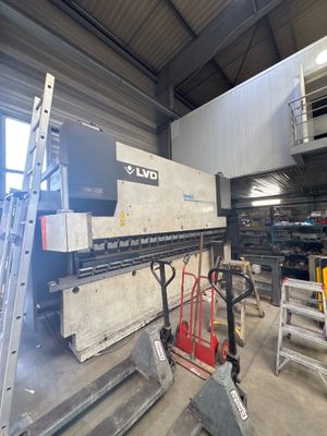an image of a large machine in a warehouse with a ladder