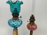 two glass lamps that are sitting on a table