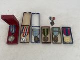several medals and medals are arranged in a row on a white surface
