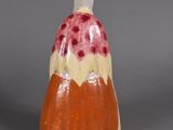 a small vase that has a red and white design on it