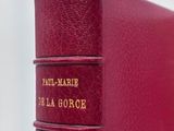 a close up of a red book sitting on top of a table