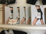 many boxes of underwear on a shelf in a store