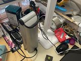 a laptop computer sitting on a cluttered desk with other office supplies