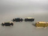 four miniature cars are lined up in a row on a table