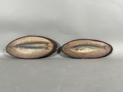 a pair of antique brass fish figurines on wooden bases