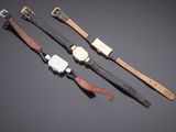 three different types of watches on a gray background