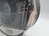 a spool of black plastic tape on a white surface