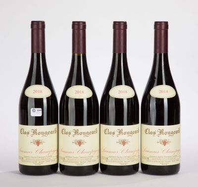 three bottles of red wine sitting next to each other on a table
