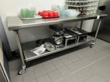 a stainless steel table with a bunch of dishes on it