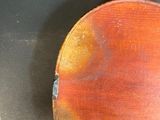 a close up of a violin on a black surface