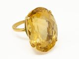 a close up of a ring with a large citrine stone in it