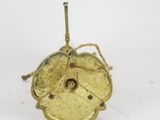 an image of a gold apple shaped candle holder on a white surface