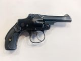 a close up of a revolver on a white surface
