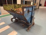 a blue dumpster sitting in the middle of a building