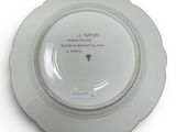 a white plate with a quote on it sitting on a table