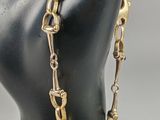 a close up of a mannequin head with a chain around it