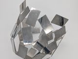 a metal sculpture that looks like a ball of metal