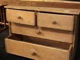 a tennis racket sitting next to a wooden chest of drawers