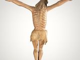 a statue of jesus on the cross with his arms outstretched