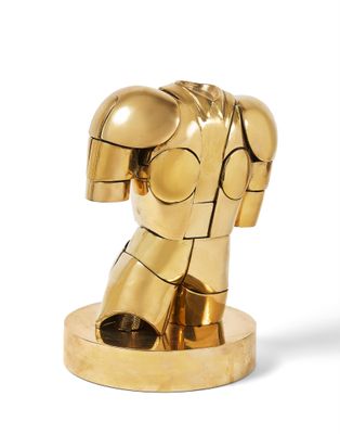 gold iron man statue on a white surface with a white background