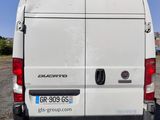 the back end of a white van parked in a parking lot