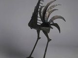 statue of a bird made of metal on a white background