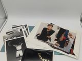 a lot of photos on a table with a laptop