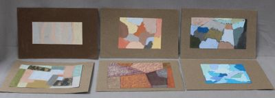 several pieces of art are displayed on a table in front of a white background