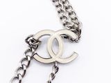 a close up of a chain with a chanel logo on it