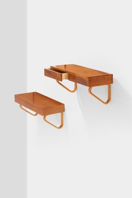 two wooden shelves with a drawer and a shelf with a drawer underneath them