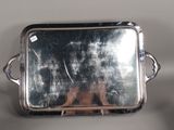 a silver tray with a mirror on it on a table