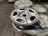 a pile of rims and tires on a pallet