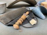 a wooden bead and a cloth bag on a table