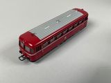 a red train on a white table with a white background