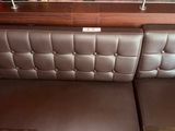 a picture of a booth with two tables and a picture on the wall