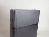 a black computer sitting on top of a white table
