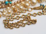 an image of a close up of a necklace with pearls and turquoise stones