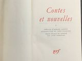 an open book with red writing on it sitting on a table