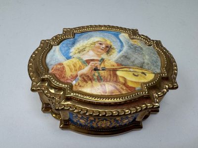 a gold box with a picture of an angel on it
