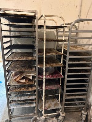 many trays of food that are sitting on a cart