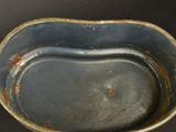 a blue bowl with a brown rim sitting on a black surface
