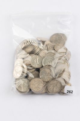 a bag full of silver coins on a white surface
