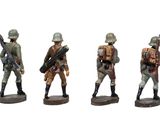 three figurines of soldiers with rifles and backpacks on a white background